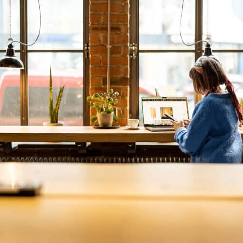 Woman working on her webshop in a industrial office.